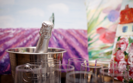 glasses of champagne and a bottle of champagne standing on the tableの写真素材