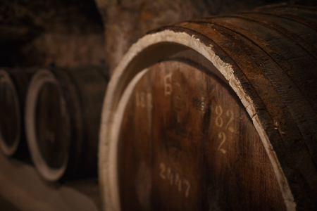 old wine cellar with large wooden wine barrels in Ukraineの写真素材