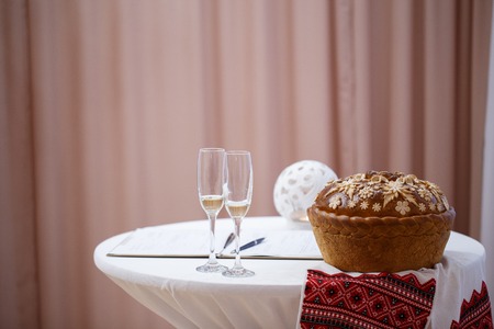Glasses of champagne, white tablecloths and beautiful loaf in the registry officeの写真素材