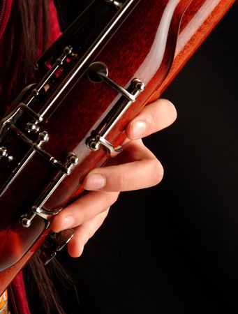 Close up to a hand playing bassoonの写真素材