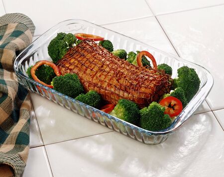 A rasted pork loin roast over a white backgroundの写真素材