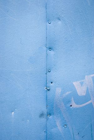 Blue metal plate with rivetsの写真素材