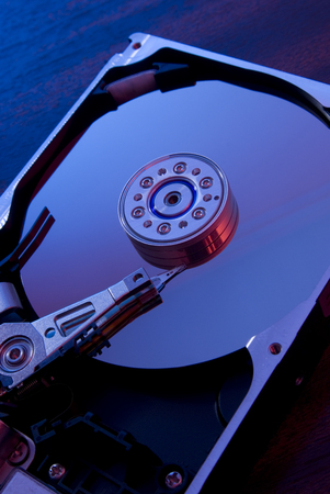 close up of open hard disk drives with bluish reflections