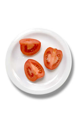 Sliced tomato over white dish isolated on whiteの写真素材