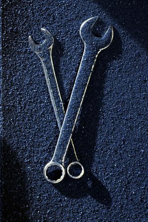 A set of wrenches over a colored sand backgroundの写真素材