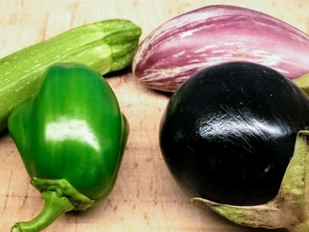 green pepper,pumkin and eggplant on wooden tableの写真素材