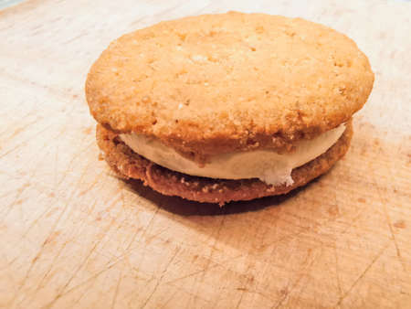 biscuit sandwich with cream on wooden backgroundの写真素材