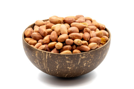 Peanuts isolated on white background. Peanuts in a coconut bowl. Studio shoot. close up
