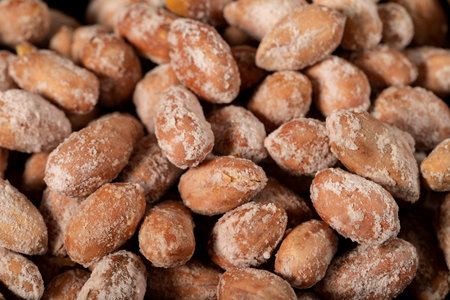Salted peanuts on dark background. Pile of peanuts. Studio shoot. close upの写真素材
