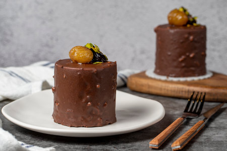 Chocolate and chestnut cake on a dark background. Delicious cake with cream filling. Studio shoot....