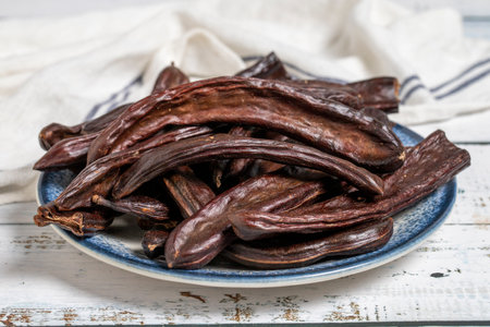 Carob on wood background. healthy food. close up