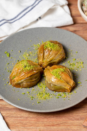Mussel baklava with pistachio on wooden background. Turkish cuisine delicacies. Turkish baklava....
