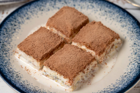 Cold baklava on a white wooden background. Baklava with milk and pistachio. Mediterranean cuisine...
