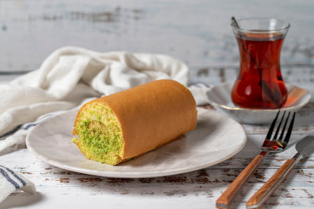 Roll Cake with Banana on a white wooden background. patisserie desserts