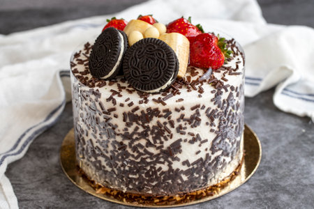 Cake with fruit and biscuit pieces on a dark background. close up