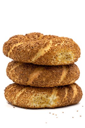 Turkish bagel or crispy. traditional flavors. Bagel with sesame isolated on white background. close...
