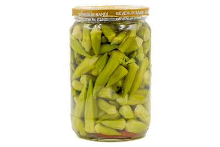 Canned okra in glass jar isolated on white backgroundの写真素材