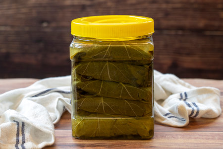 Cnned grape leaves on wood background. local name grape leafの写真素材