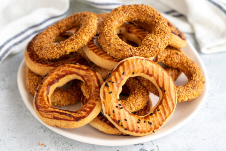 Sesame bagel on a gray background. Traditional Turkish cuisine delicacies. local name lamp ring
