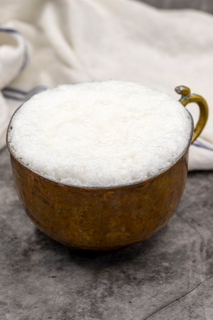 Sparkling buttermilk in a copper glass. Traditional Turkish food. Drink made with yogurt. close upの写真素材