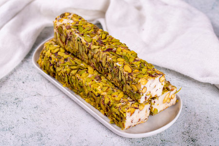 Turkish delight with pistachio on a gray background. Turkish delight with milk. close-up. local name...
