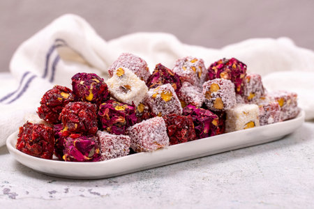 Mixed Turkish delight. Assortment of Turkish delight with pistachio on a gray background....