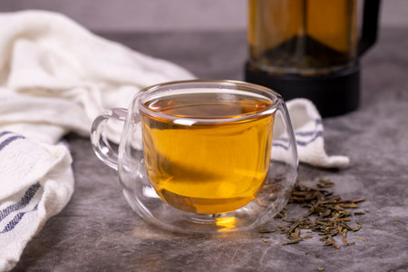 green tea. Green tea brewed with French press on a dark background. healthy drinks. Herbal tea...