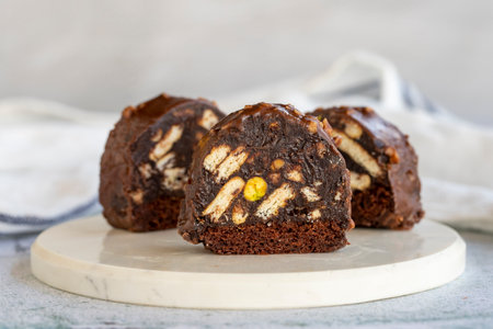 Mosaic cake. Mosaic cake with pistachio on a stone background. Chocolate little cake. close upの写真素材