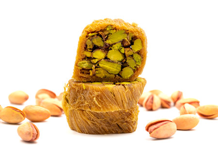 Pistachio kadayif. Kadayif baklava isolated on white background. Traditional Turkish cuisine delicacies. Kadayif dessert with syrup filled with pistachios in the middle. close upの写真素材