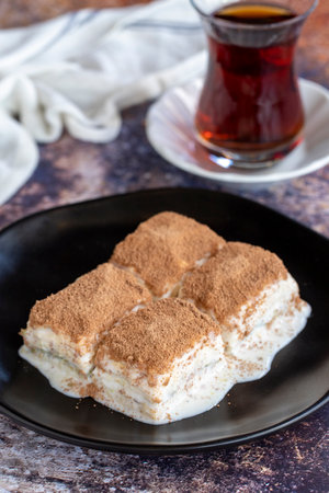 Cold baklava. Baklava with milk on a colored background. Turkish cuisine delicacies. close upの写真素材