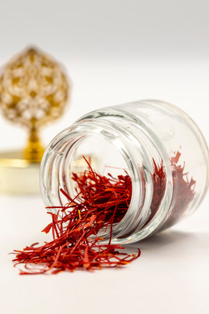 Packaged Iranian saffron in glass bottle on white background. close upの写真素材
