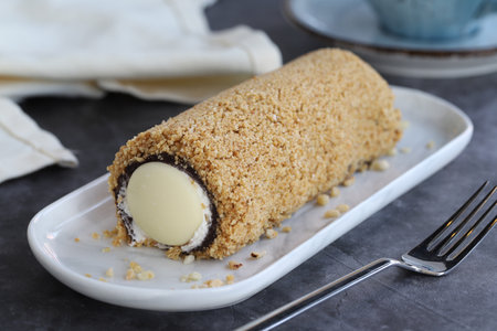 Flowing chocolate roll cake. Chocolate cake on dark background. close up