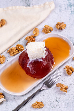 Quince dessert. Traditional Turkish cuisine delicacies. Quince dessert with cream on a stone...