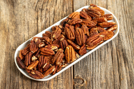 Pecan walnuts on wooden background. close up