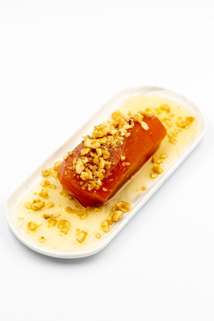 Pumpkin dessert. Traditional Turkish cuisine dessert. Pumpkin dessert with syrup sprinkled with...