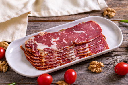 Turkish pastrami. Bacon made from ribeye meat. Beef pastrami sliced Pastirma or Turkish pastrami. close-up.の写真素材
