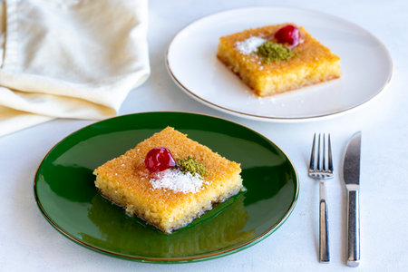Kadayif dessert with pistachio on a white background. Traditional Turkish cuisine delicacies. close...
