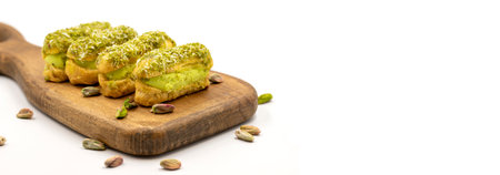 Pistachio eclair cake. Eclair cake with pistachio filling on a white background. close up. copy spaceの写真素材