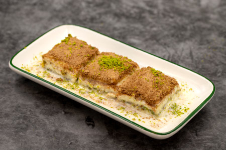 Cold baklava. Baklava with milk on a dark background. Mediterranean cuisine delicacies. close-up....