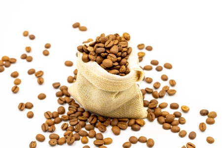 Coffee beans isolated on a white background. Full of coffee beans in a sack. close-up.の写真素材