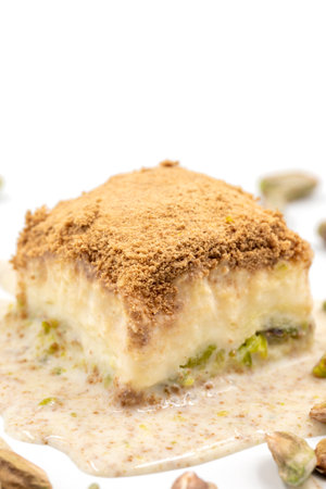 Cold baklava on a white background. Cold baklava prepared with milk and pistachio is very popular....