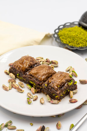 Chocolate baklava with pistachio on a white background. Traditional Mediterranean cuisine delicacies. Close-up Chocolate Baklava. local name chocolate baklavaの写真素材