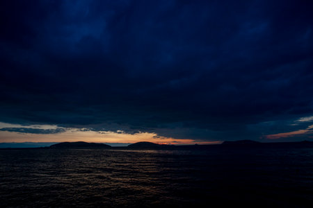 The sun goes down as the storm approachesの写真素材