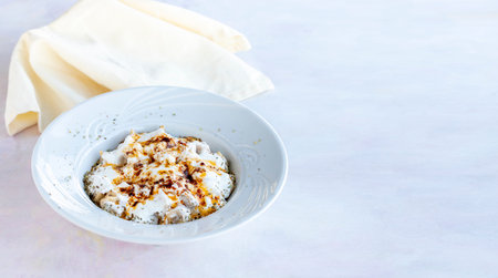 Ravioli with garlic and yoghurt on a white wooden background