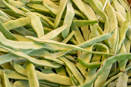 fresh green beans at the market. green beans in bulk. ripe green beans in a street market