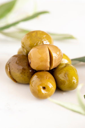 Close-up of green kalamata olives. Organic olives on a marble floorの写真素材