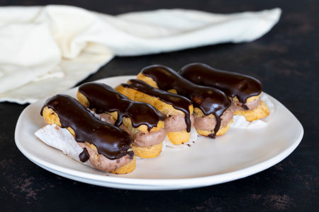 Chocolate eclair cake on dark background
