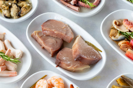 Set of Seafood Dishes. Seafood on a plate. On a white wooden background. Shrimp, lakerda, octopus salad, mussels with marinade, fish saladの写真素材