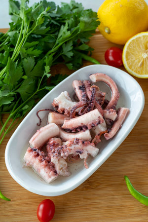 Octopus salad on wooden background. seafood dishes. local name octopus salad