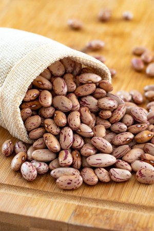 Raw Organic cranberry bean on wooden background.の写真素材
